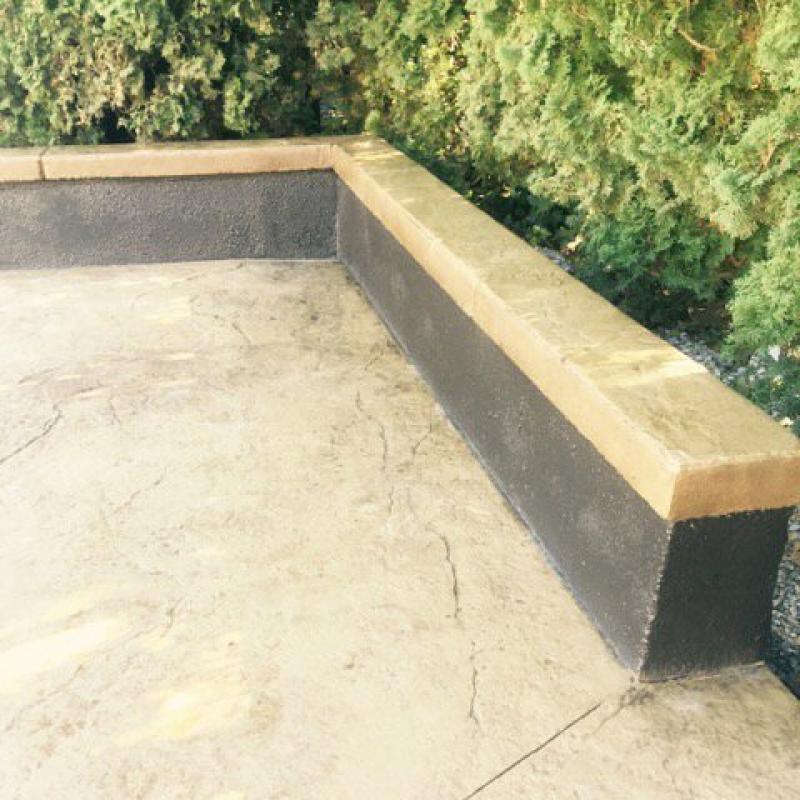 A concrete bench sitting on top of cement.