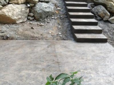 A concrete walkway with steps leading to the ground.