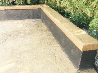 A concrete bench sitting on top of cement.